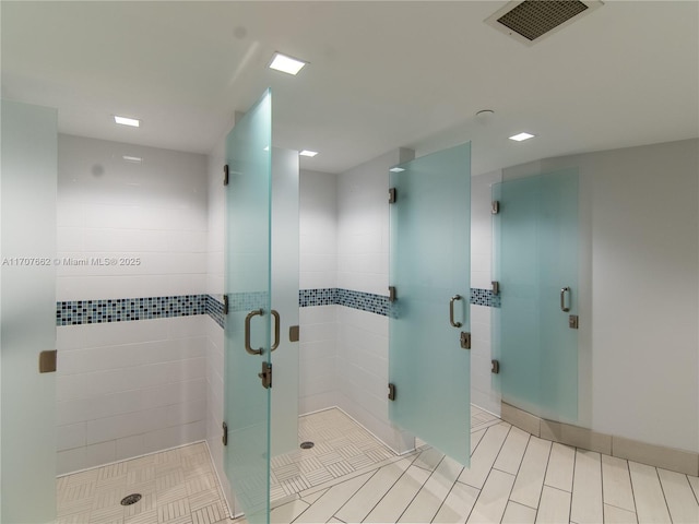 bathroom with a shower with door