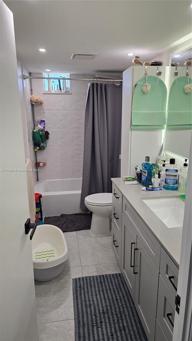 full bathroom featuring vanity, toilet, tile patterned flooring, and shower / bath combo with shower curtain