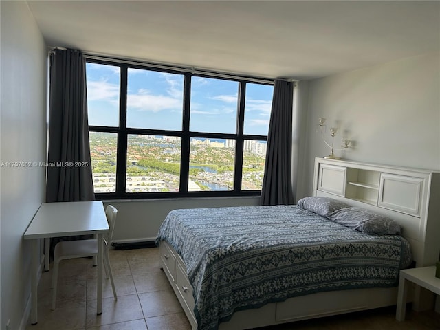 bedroom featuring multiple windows and light tile patterned floors