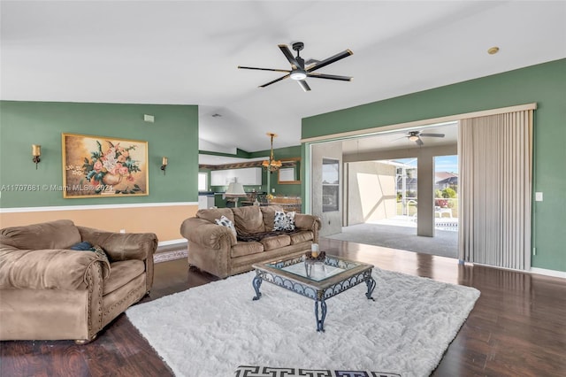 living room with dark hardwood / wood-style flooring and lofted ceiling