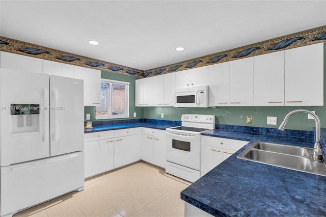 kitchen featuring white cabinetry, sink, and white appliances