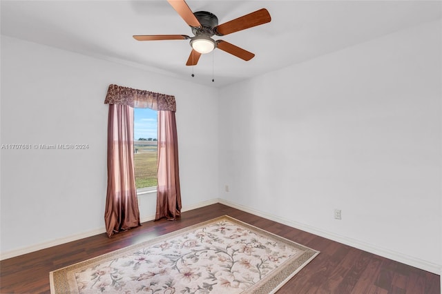 spare room featuring ceiling fan and dark wood-type flooring