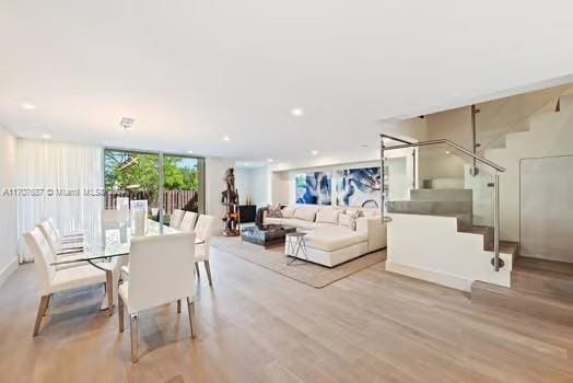 dining space with light hardwood / wood-style floors and floor to ceiling windows