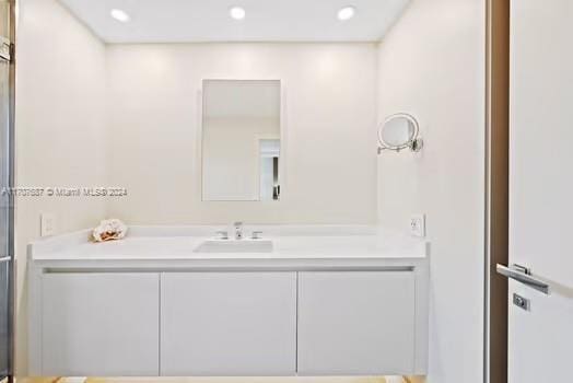 bathroom featuring vanity and an enclosed shower