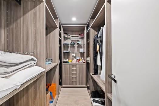 spacious closet with light hardwood / wood-style flooring