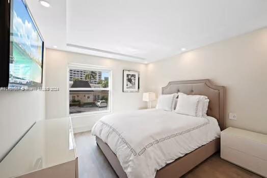 bedroom with hardwood / wood-style flooring