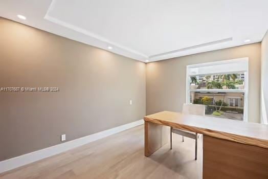 unfurnished office with light wood-type flooring