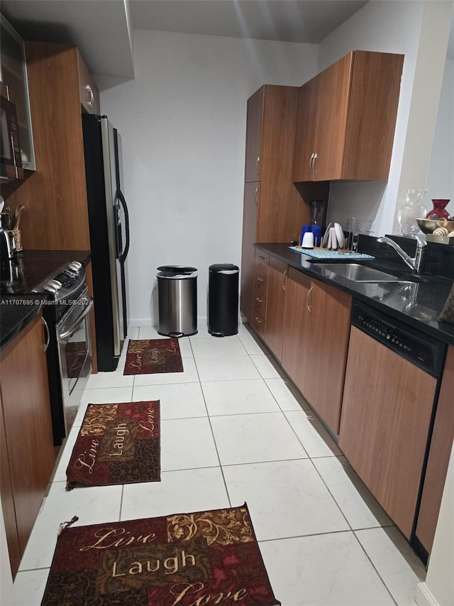 kitchen with sink, light tile patterned floors, and appliances with stainless steel finishes