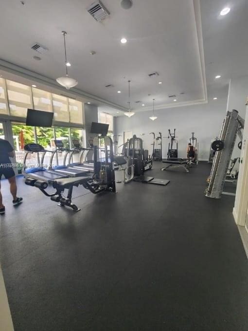 workout area featuring ornamental molding