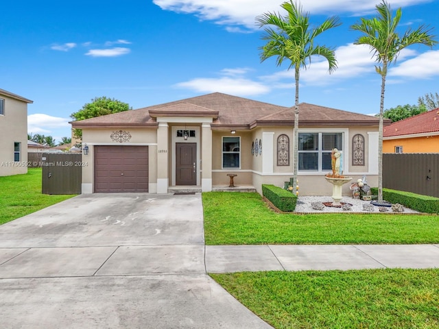 view of front of home featuring a front yard and a garage