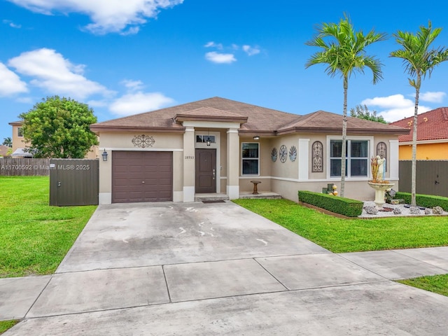 view of front of house featuring concrete driveway, a front lawn, an attached garage, and stucco siding