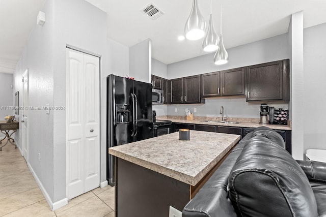 kitchen featuring dark brown cabinetry, sink, black appliances, pendant lighting, and a kitchen island