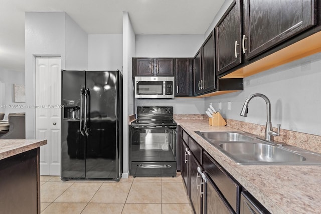 kitchen featuring black appliances, dark brown cabinets, light tile patterned floors, and sink