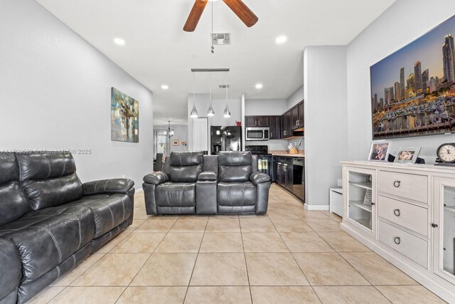 living room with ceiling fan and light tile patterned flooring