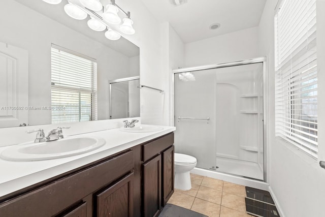 bathroom featuring tile patterned flooring, vanity, an enclosed shower, and toilet