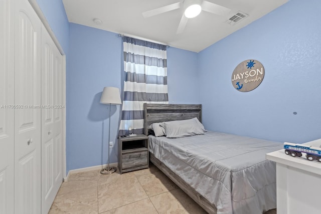 tiled bedroom featuring ceiling fan and a closet