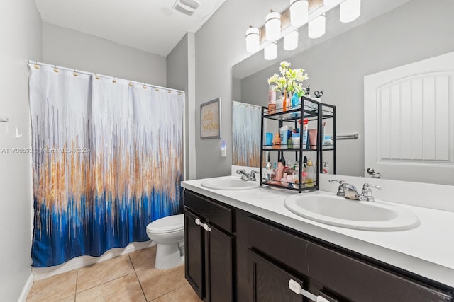 bathroom with tile patterned floors, vanity, and toilet