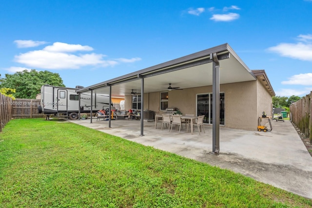 rear view of property with ceiling fan, a patio, a fenced backyard, and stucco siding