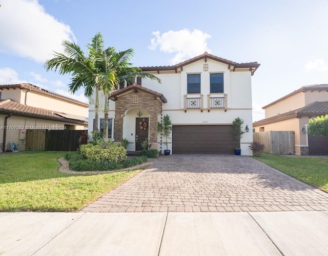 mediterranean / spanish house featuring a front lawn and a garage