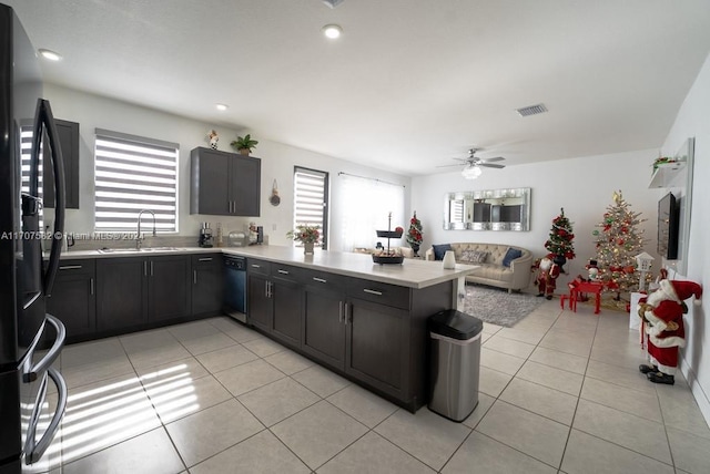 kitchen with black appliances, sink, ceiling fan, light tile patterned flooring, and kitchen peninsula