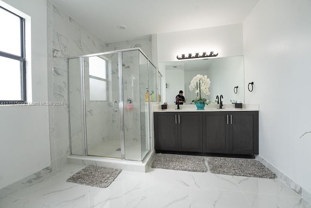 bathroom featuring vanity and a shower with shower door