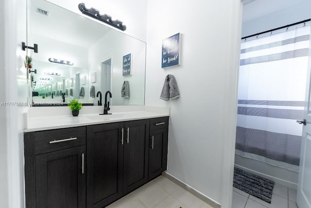 bathroom with tile patterned floors, a shower with curtain, and vanity