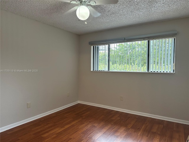 empty room with a textured ceiling, ceiling fan, and dark wood-type flooring