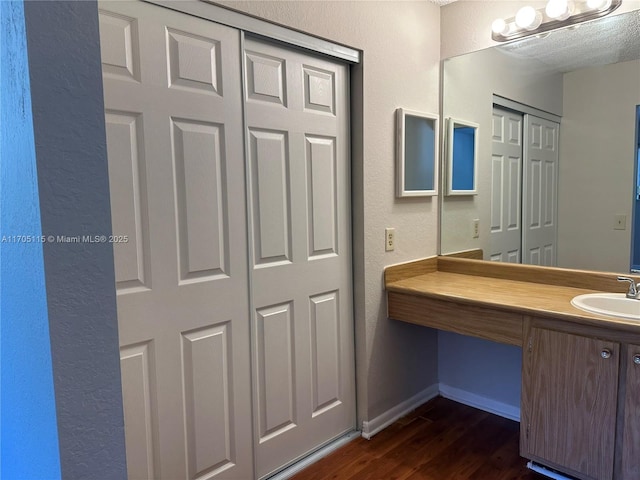 bathroom with hardwood / wood-style flooring and vanity