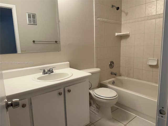 full bathroom featuring tile patterned flooring, vanity, tiled shower / bath combo, and toilet