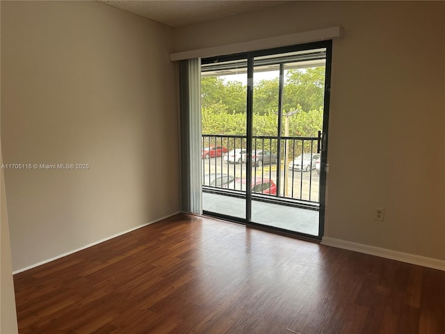 unfurnished room with hardwood / wood-style floors