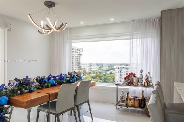 dining room featuring light tile patterned floors and a notable chandelier