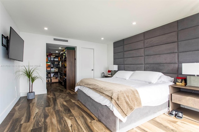 bedroom with dark hardwood / wood-style flooring