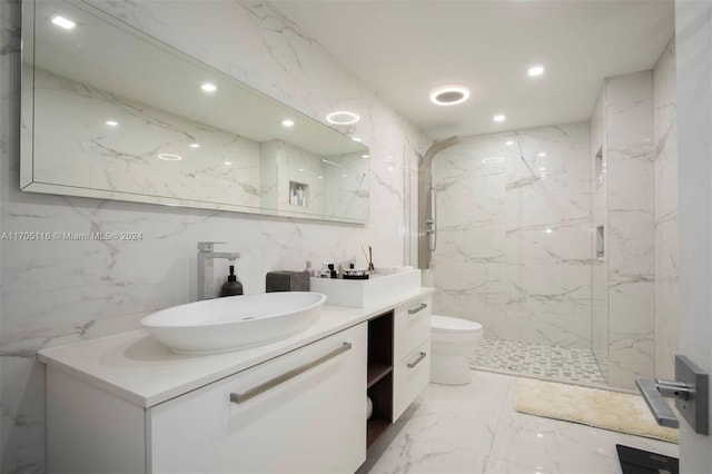 bathroom featuring a shower with door, vanity, tile walls, and toilet