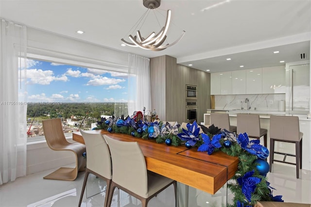 dining room with sink and a chandelier