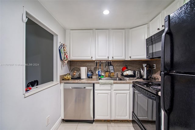 kitchen featuring black appliances, light countertops, a sink, and white cabinetry