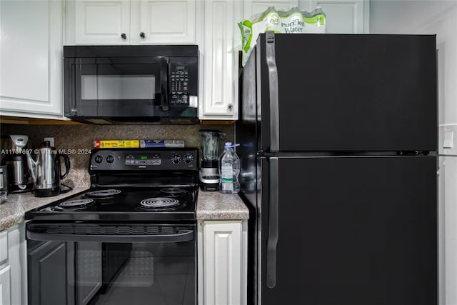 kitchen featuring tasteful backsplash, white cabinetry, and black appliances