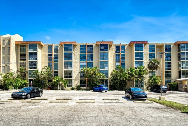 view of property with uncovered parking