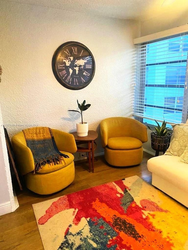 sitting room with dark hardwood / wood-style flooring