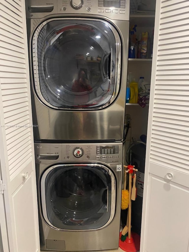 clothes washing area with stacked washer and clothes dryer