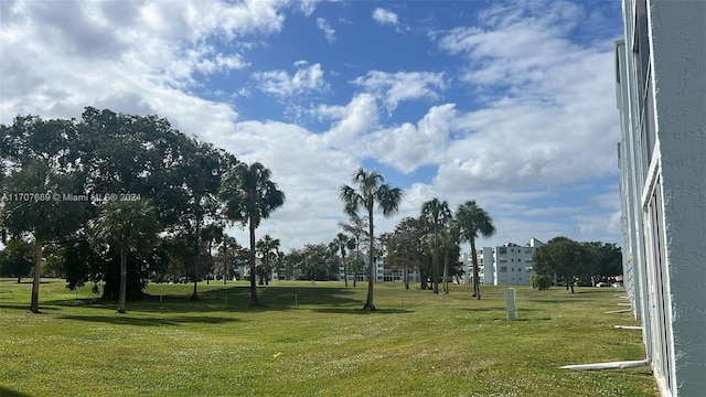 view of property's community featuring a yard