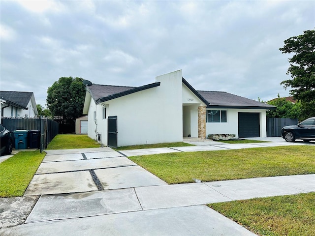 view of front of house with a garage and a front lawn