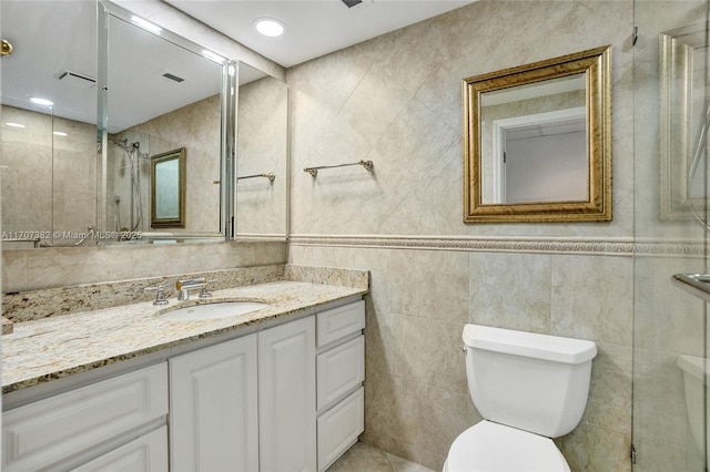 500 Bayview Dr Unit 118, Sunny Isles Beach, FL 33160 - bathroom with vanity, toilet, tile walls, and a tile shower