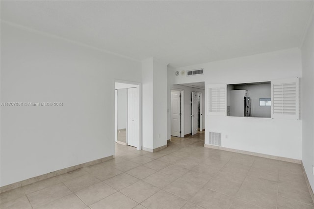 unfurnished room featuring light tile patterned floors