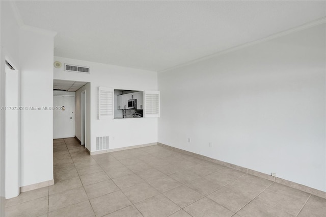 unfurnished room with light tile patterned flooring and ornamental molding