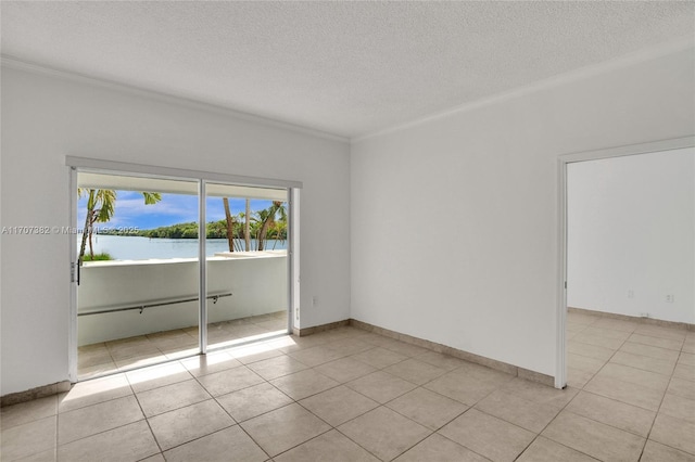 500 Bayview Dr Unit 118, Sunny Isles Beach, FL 33160 - unfurnished room with a textured ceiling, ornamental molding, a water view, and light tile patterned floors