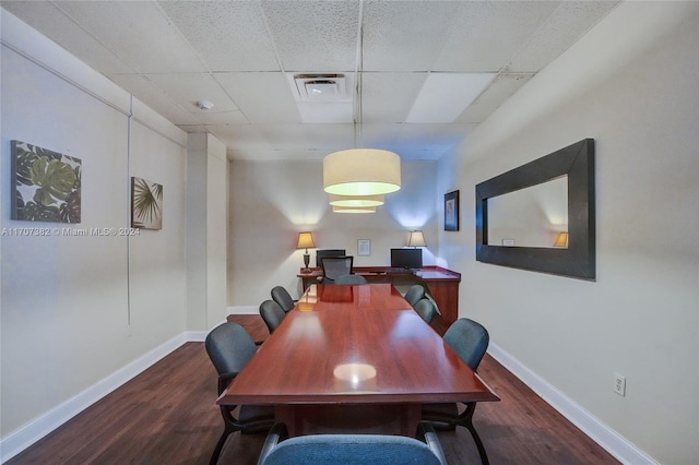 office space with a paneled ceiling and dark hardwood / wood-style floors