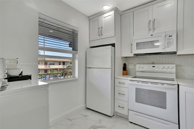 kitchen featuring white appliances, white cabinetry, and backsplash