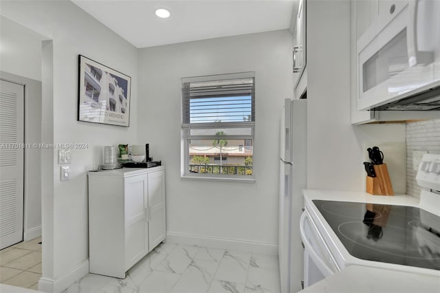 7200 NW 5th Ct Unit 206, Margate, FL 33063 - kitchen with white appliances, light countertops, white cabinetry, recessed lighting, and light marble finish floors