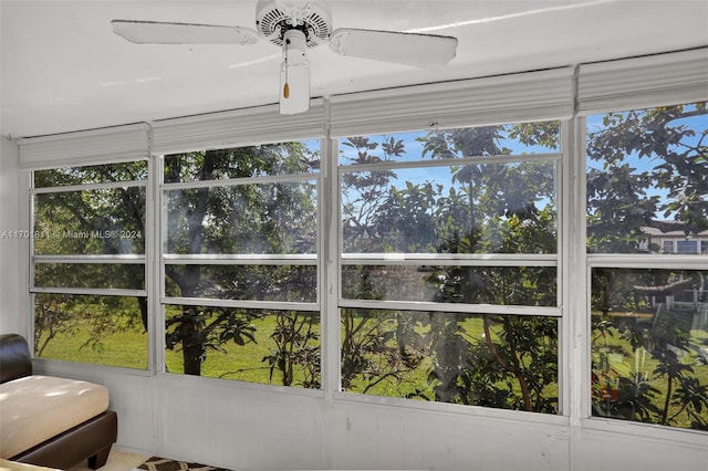 sunroom / solarium with ceiling fan and a healthy amount of sunlight