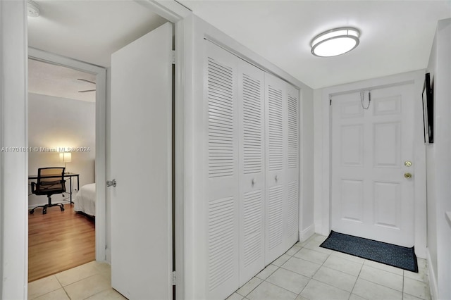 corridor featuring light tile patterned floors